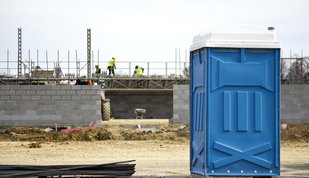 Standard portable toilet rental unit at outdoor construction site - Portable toilet rental costs