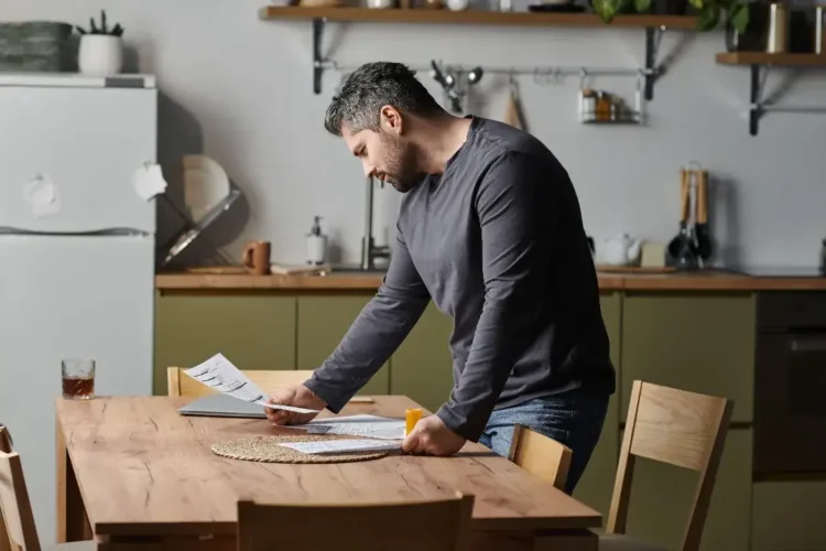 Homeowner reviewing a septic repair contractor's license and insurance documents before hiring